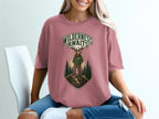 T-shirt with a deer standing on a mountain, text "Wilderness Awaits"