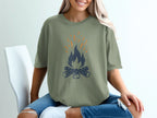 Green t-shirt with distressed campfire graphic.