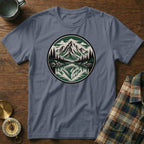 Blue t-shirt with circular mountain, lake, and forest graphic design.