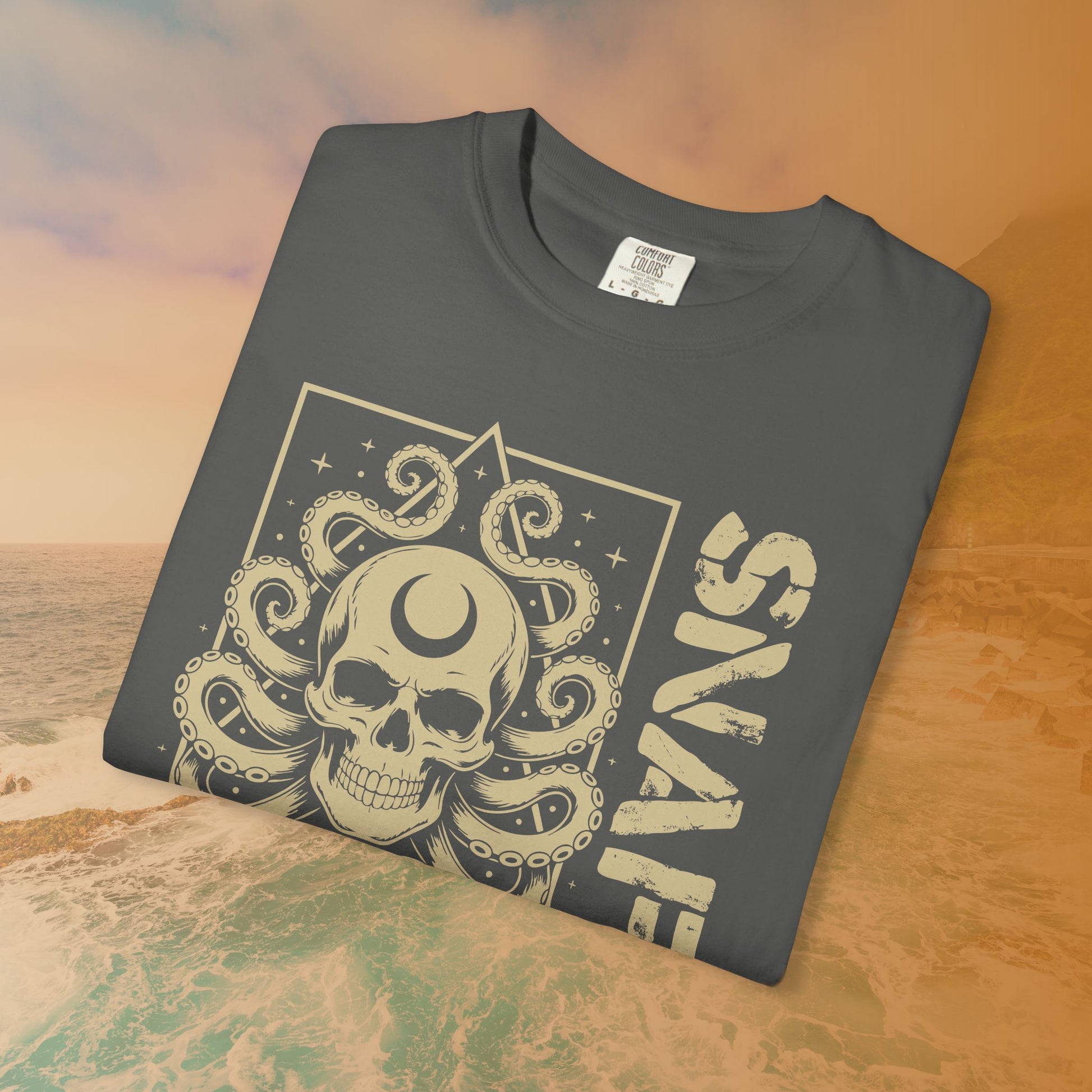 Folded dark gray t-shirt with a skull and tentacle design on a textured surface