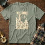 Sailboat and lighthouse graphic on a sage green t-shirt.