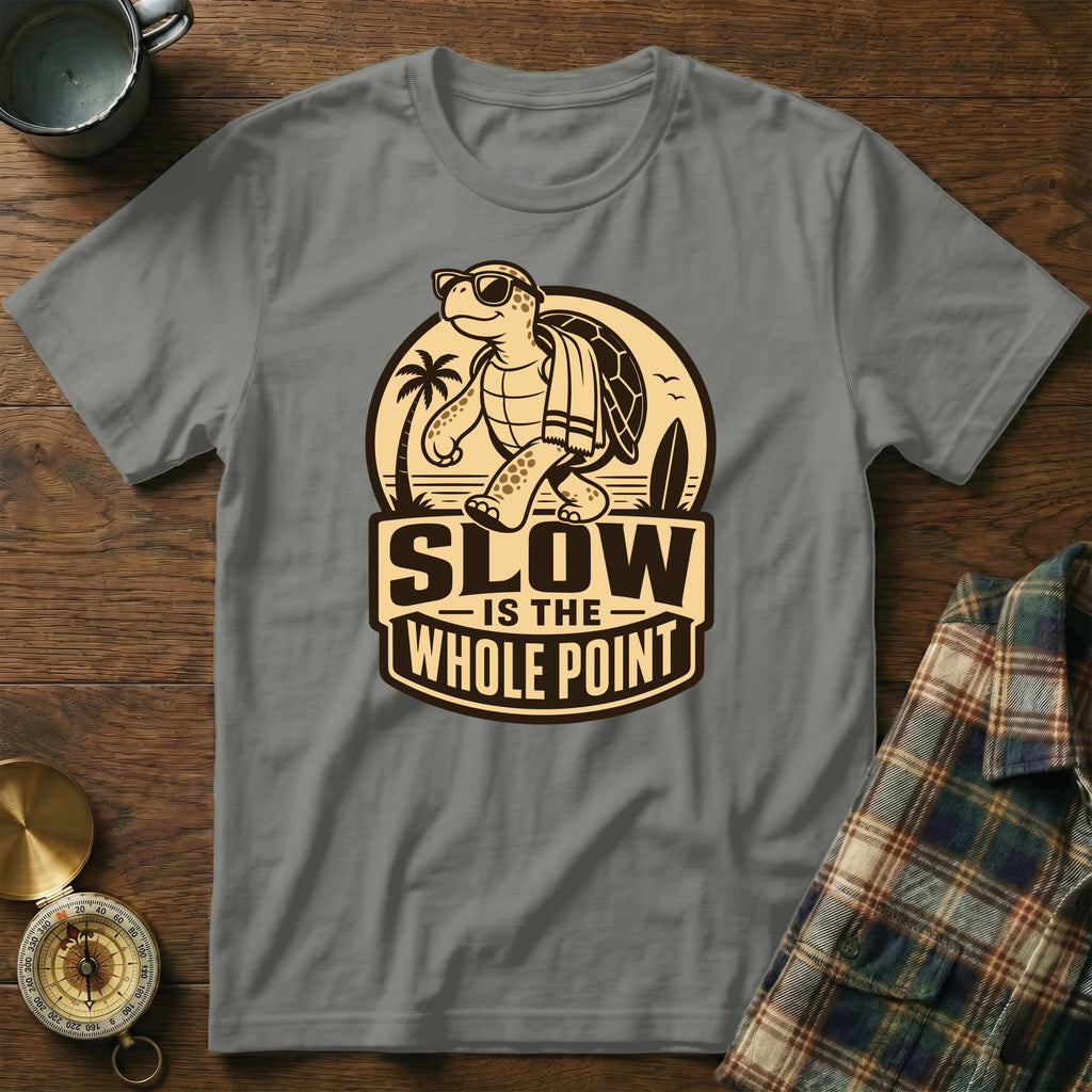 Gray t-shirt with a graphic of a turtle walking with sunglasses and a towel, saying "SLOW IS THE WHOLE POINT".