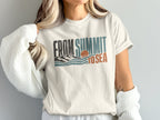 Cream t-shirt with "FROM SUMMIT TO SEA" text graphic featuring mountains, waves, and a sunset.