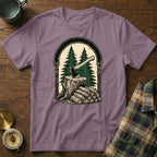 Axe and chopped wood in a forest scene, on a purple t-shirt.