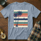 Two palm trees on a striped background with a sailboat on the horizon.