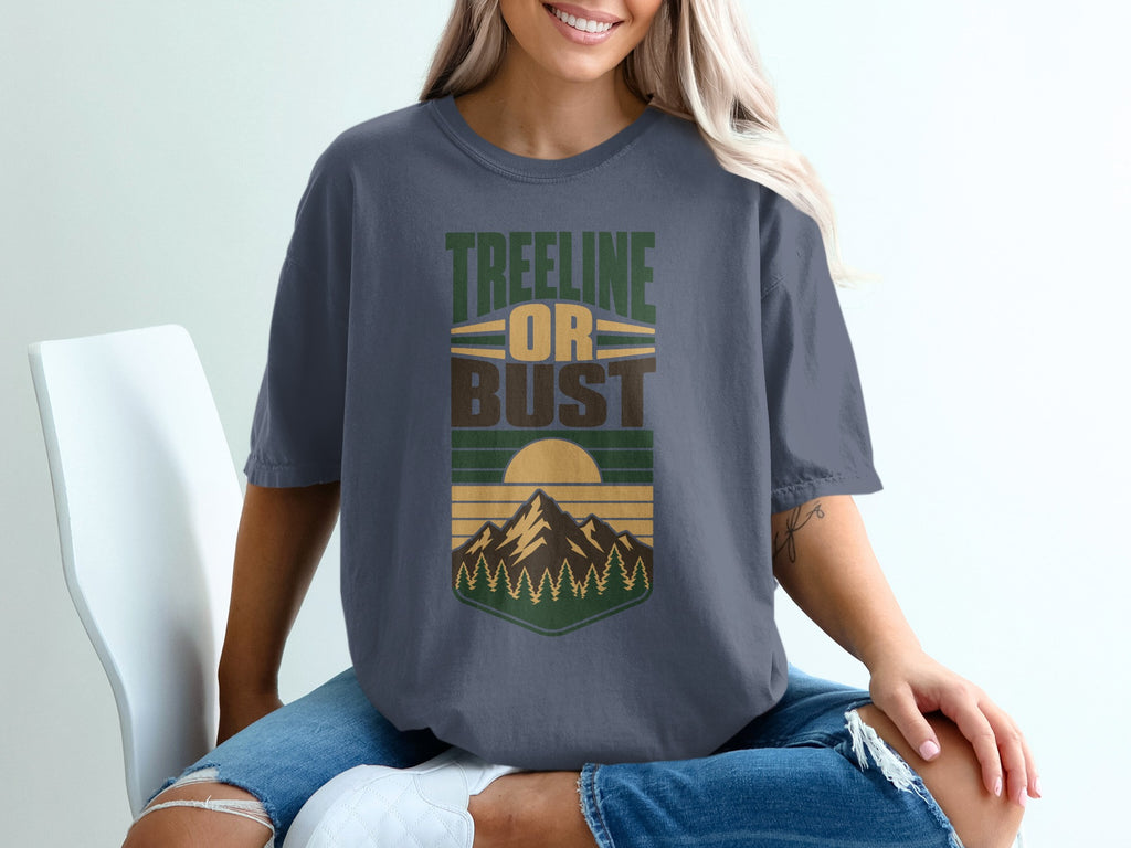 T-shirt with "Treeline or Bust" text and mountain landscape graphic.