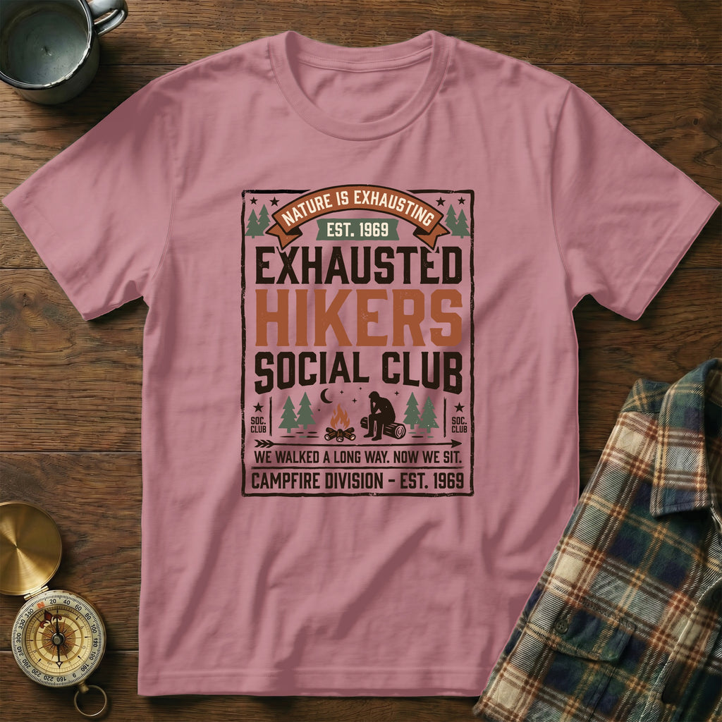 Pink t-shirt with "Nature is Exhausting" graphic and "Exhausted Hikers Social Club" text.