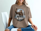 Bigfoot taking a selfie in the mountains with text "WHO'S BLURRY NOW?".