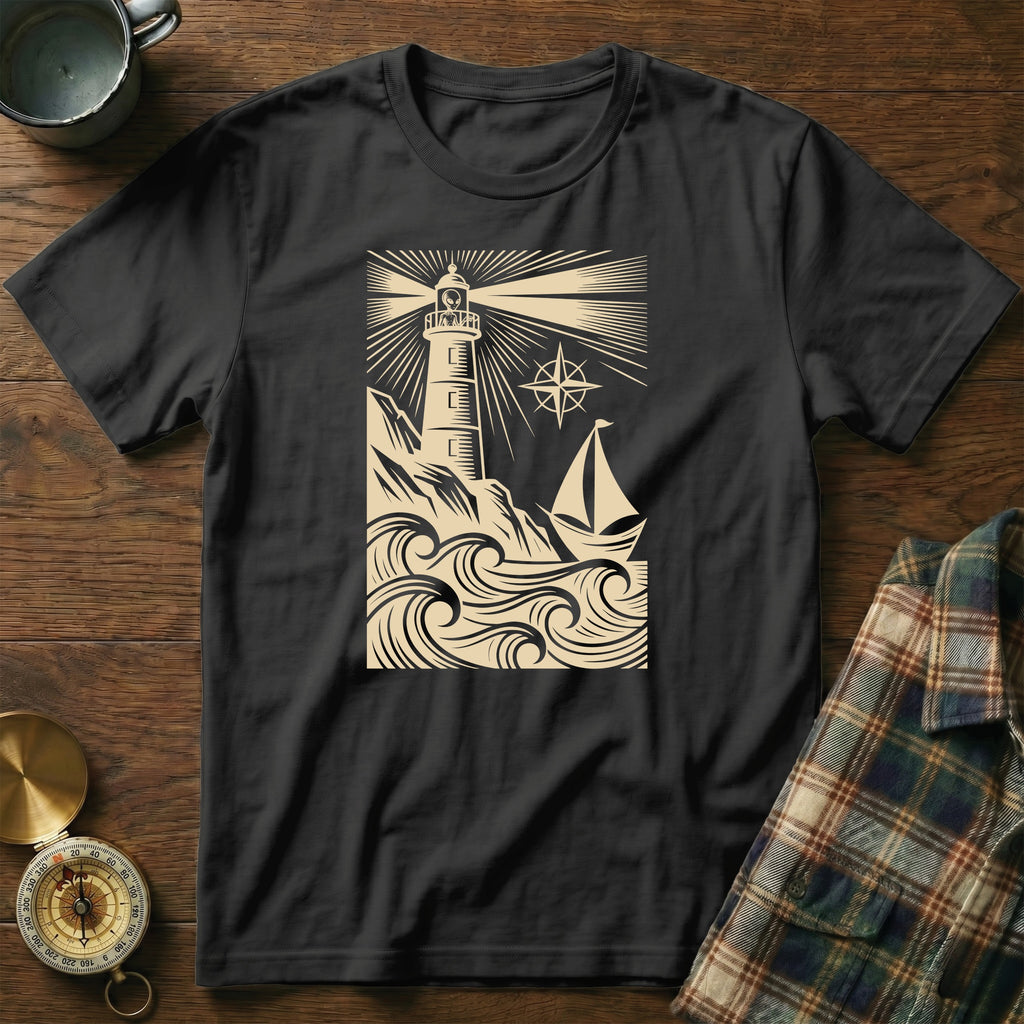 T-shirt graphic: lighthouse on a rocky coast with a sailboat in waves.