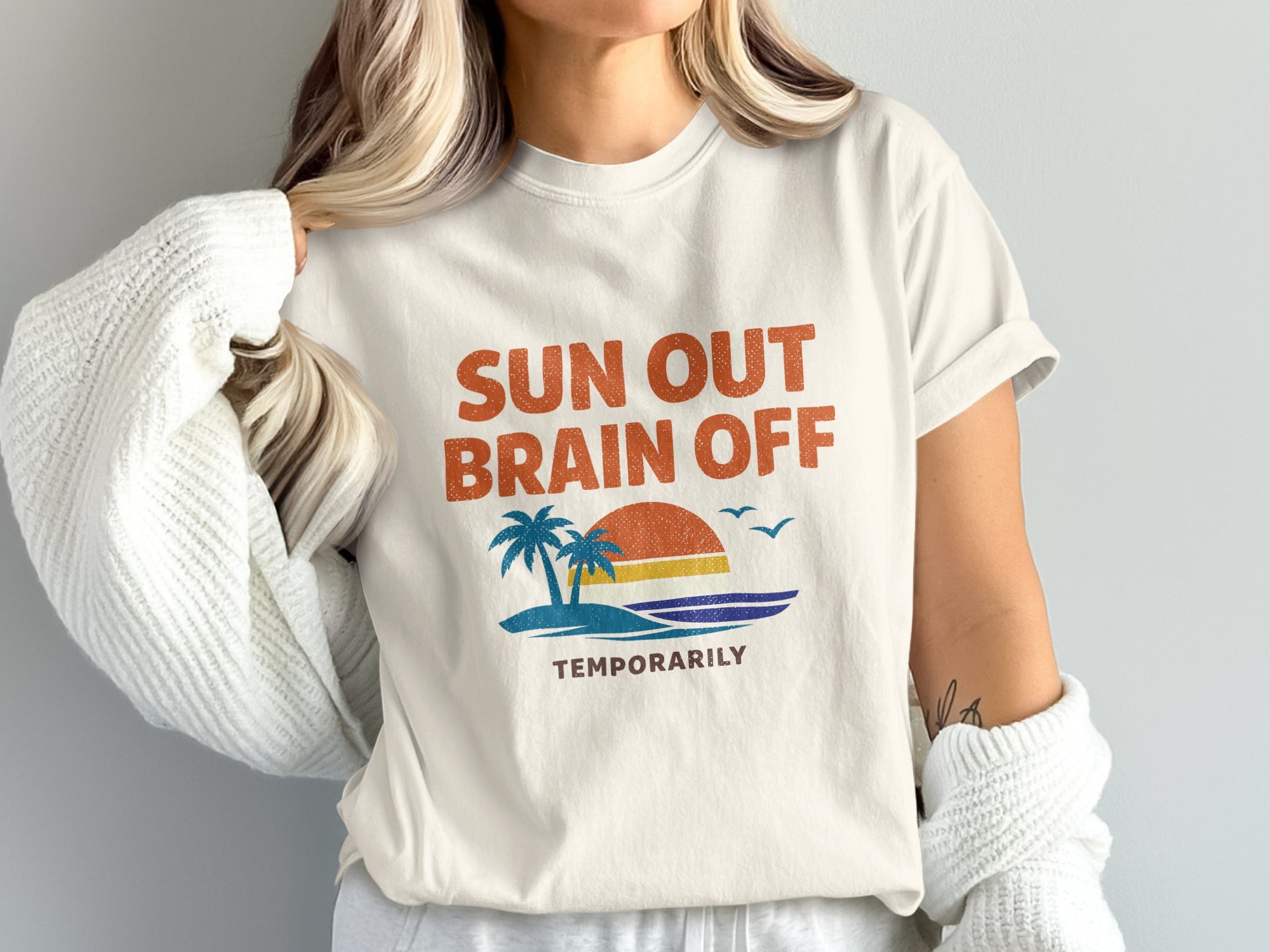White t-shirt with "Sun Out Brain Off Temporarily" text and beach graphic.
