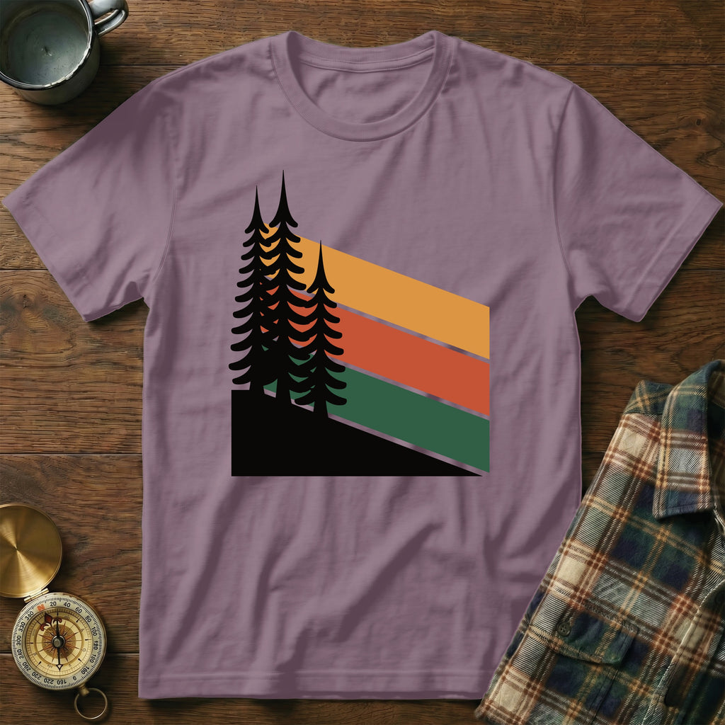 Purple t-shirt with minimalist pine trees and striped background.