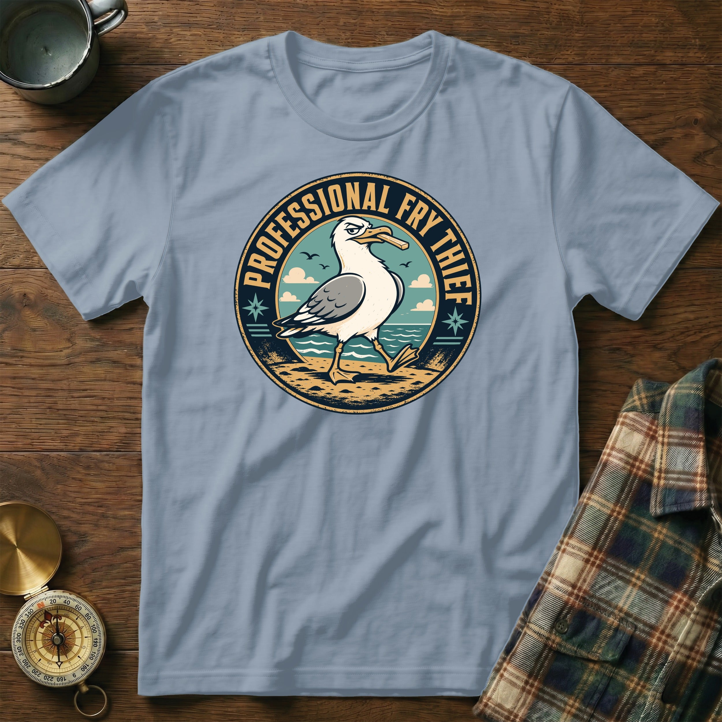 Light blue t-shirt with a seagull graphic that says "PROFESSIONAL FRY THIEF".