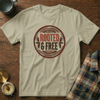 Tan t-shirt with "ROOTED & FREE" emblem and vintage style design.