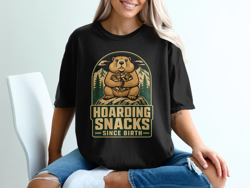 A cartoon marmot holds acorns and nuts. Text reads "Hoarding Snacks Since Birth".