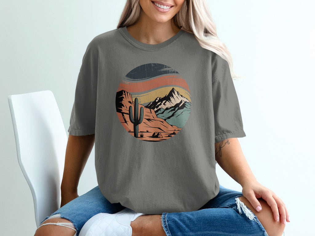 Circular desert landscape graphic on a grey t-shirt.