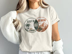 Graphic tee with "Sleep in Regret" and "Go Hiking" circular designs.