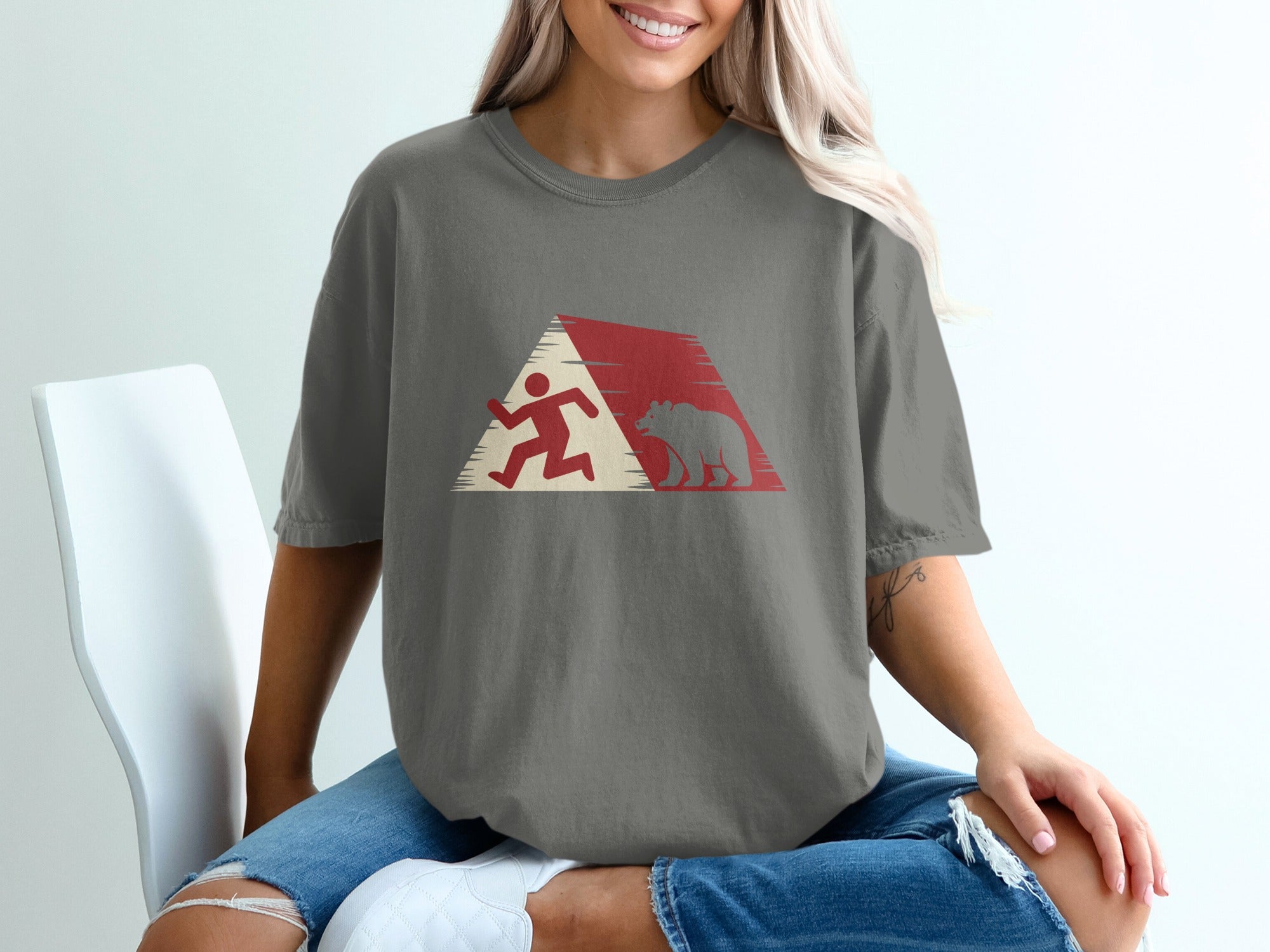 T-shirt featuring a stylized graphic of a runner and a bear within a red and white geometric design.