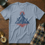 Anchor and mountain graphic on a light blue t-shirt with a sunrise motif.