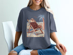 Bald eagle wearing sunglasses relaxes in a lounge chair on a beach with a palm tree.