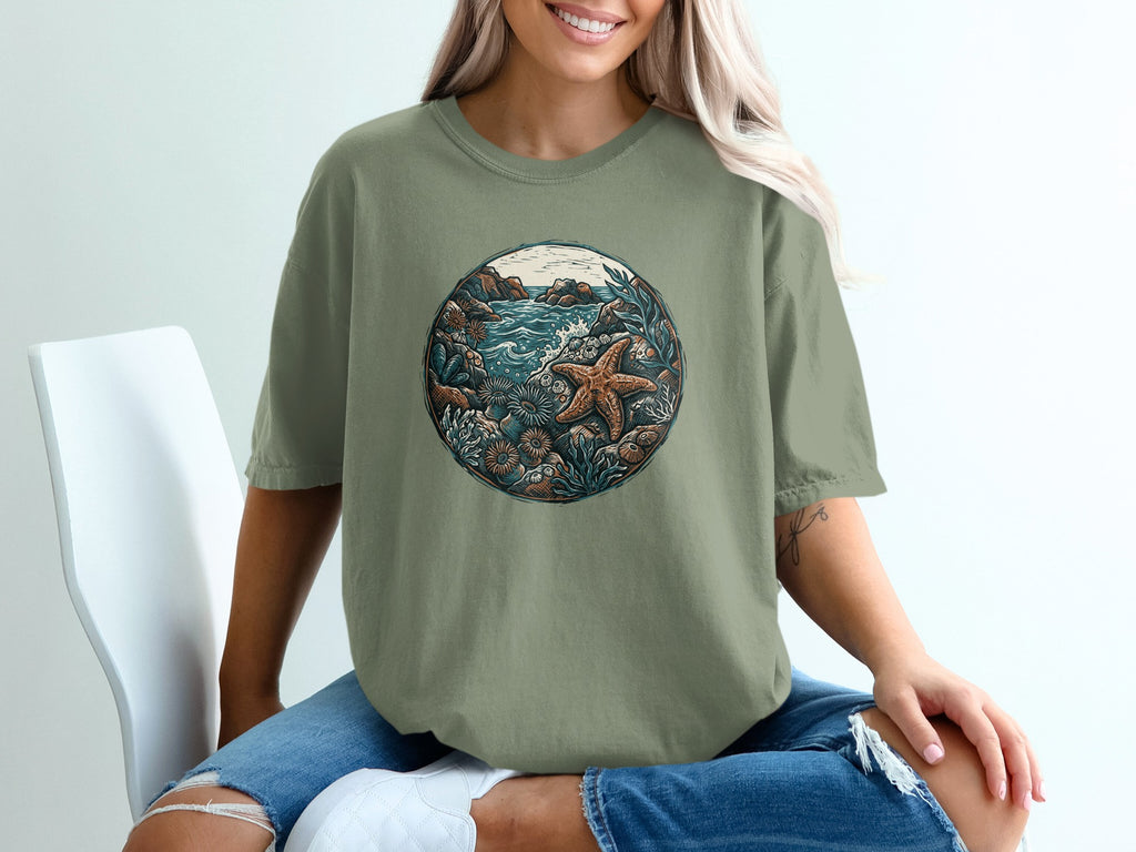 Graphic t-shirt with a circular oceanic scene and starfish.