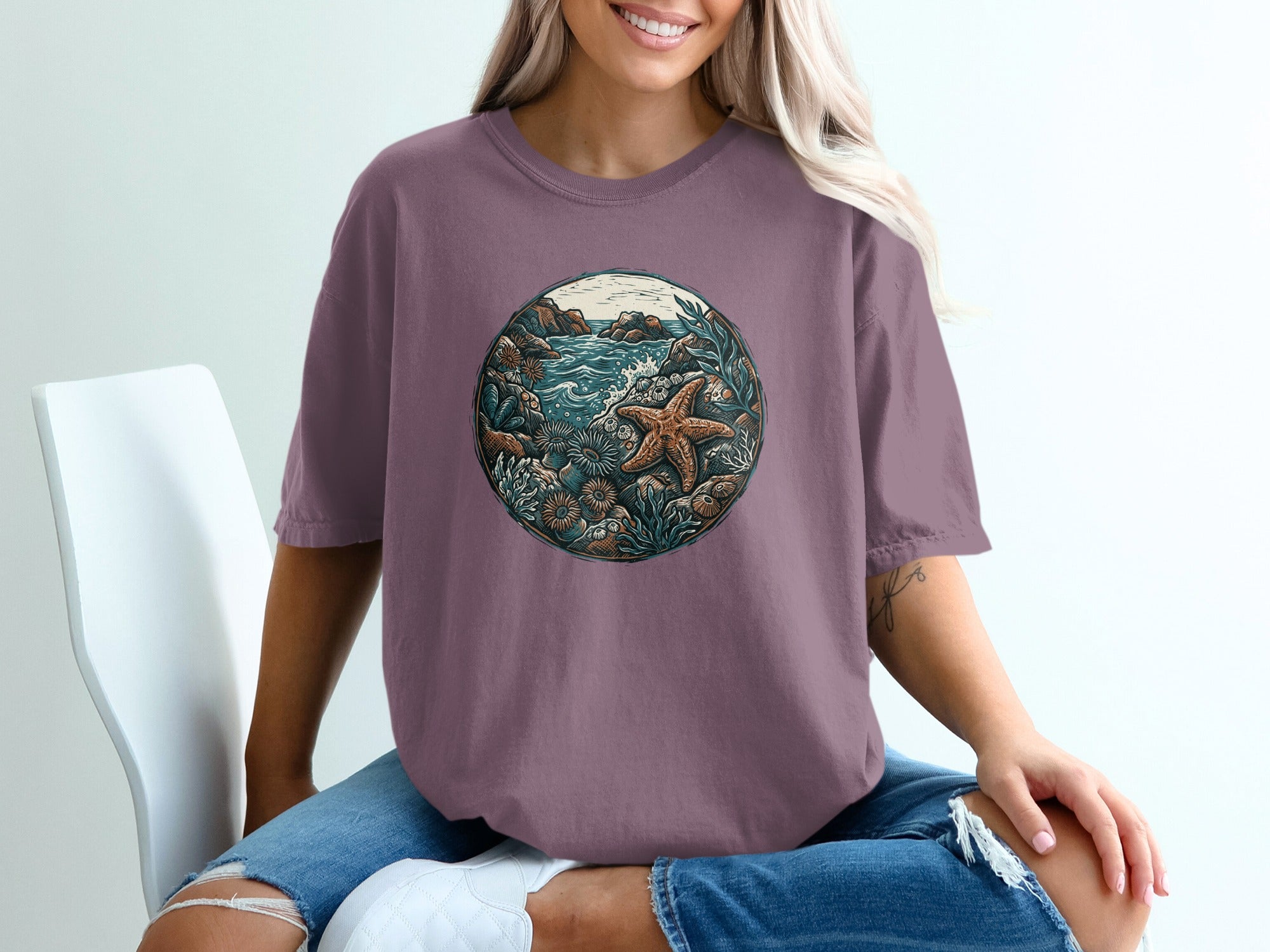 T-shirt featuring a circular ocean scene with a starfish and coral.