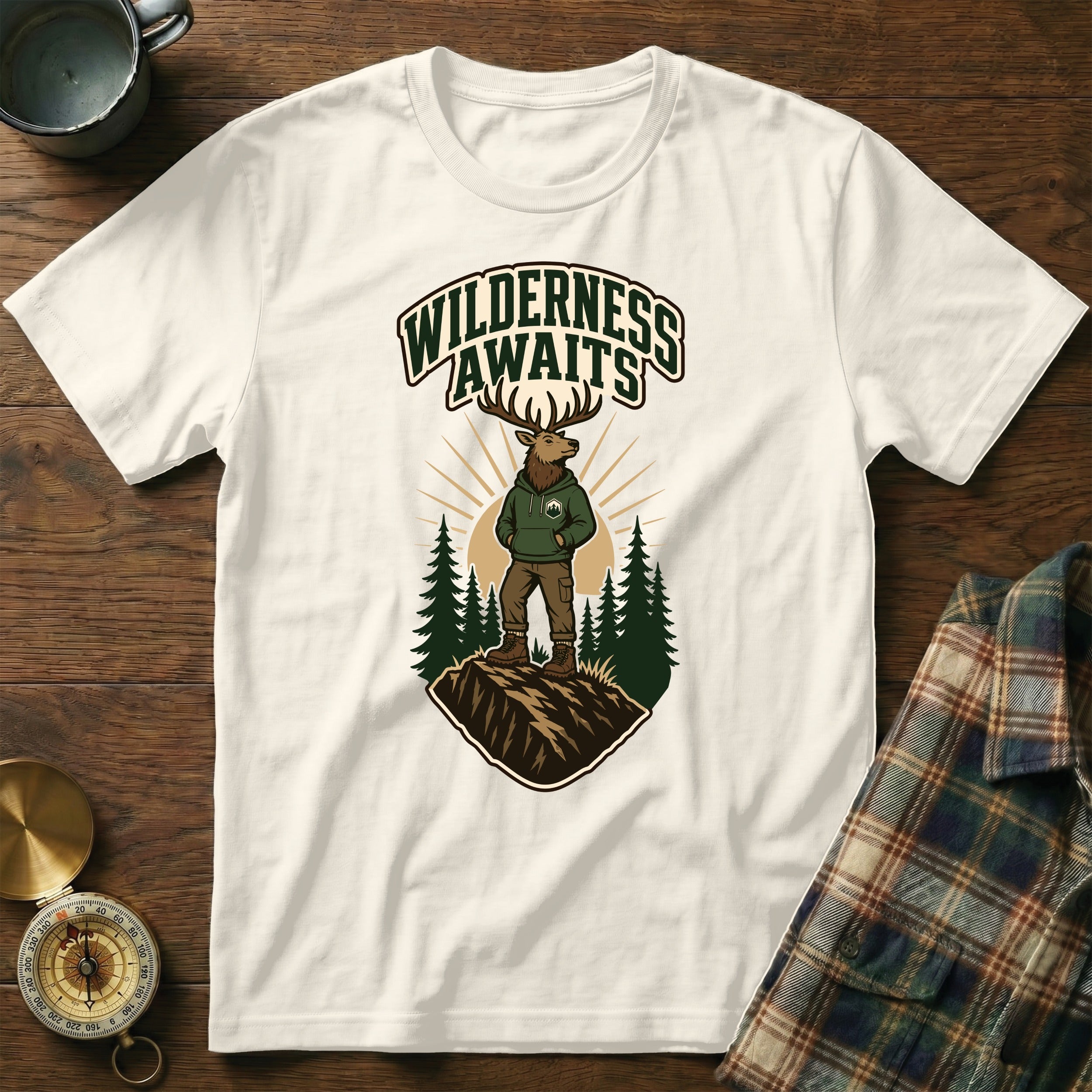 White t-shirt featuring cartoon elk and text: Wilderness Awaits.