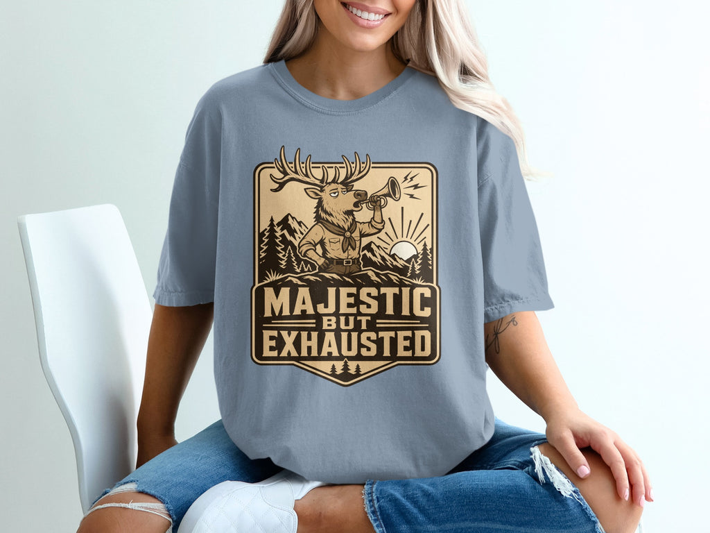 Deer wearing scout uniform playing horn reads "Majestic But Exhausted".