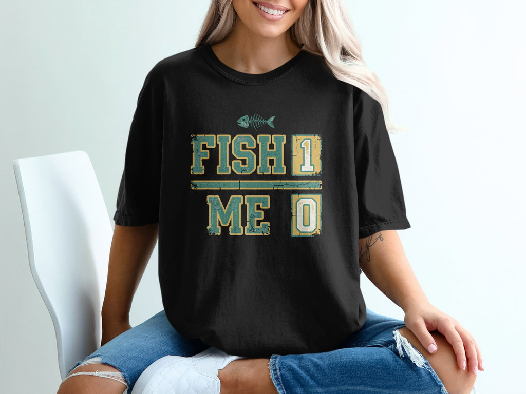 Black t-shirt with "FISH 1 ME 0" and a fish skeleton graphic.