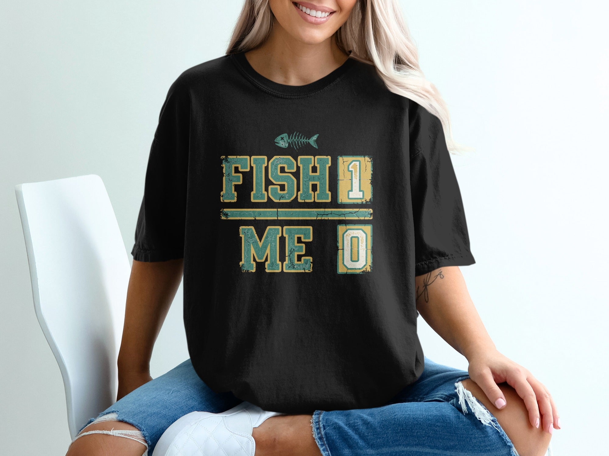Black t-shirt with "FISH 1 ME 0" and a fish skeleton graphic.