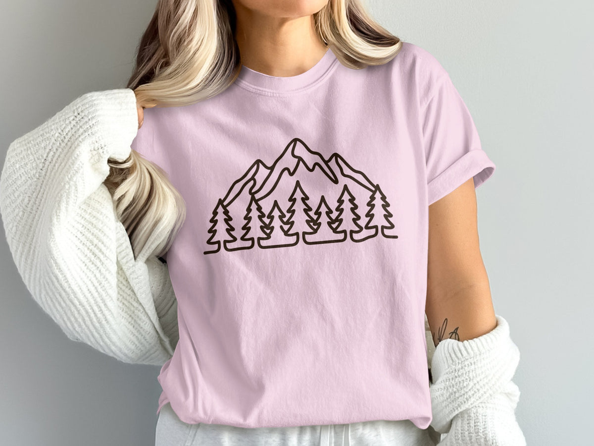 Pink t-shirt with a black line drawing of mountains and trees.