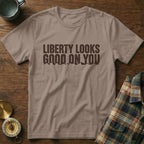 T-shirt with "Liberty Looks Good On You" printed in dark brown.