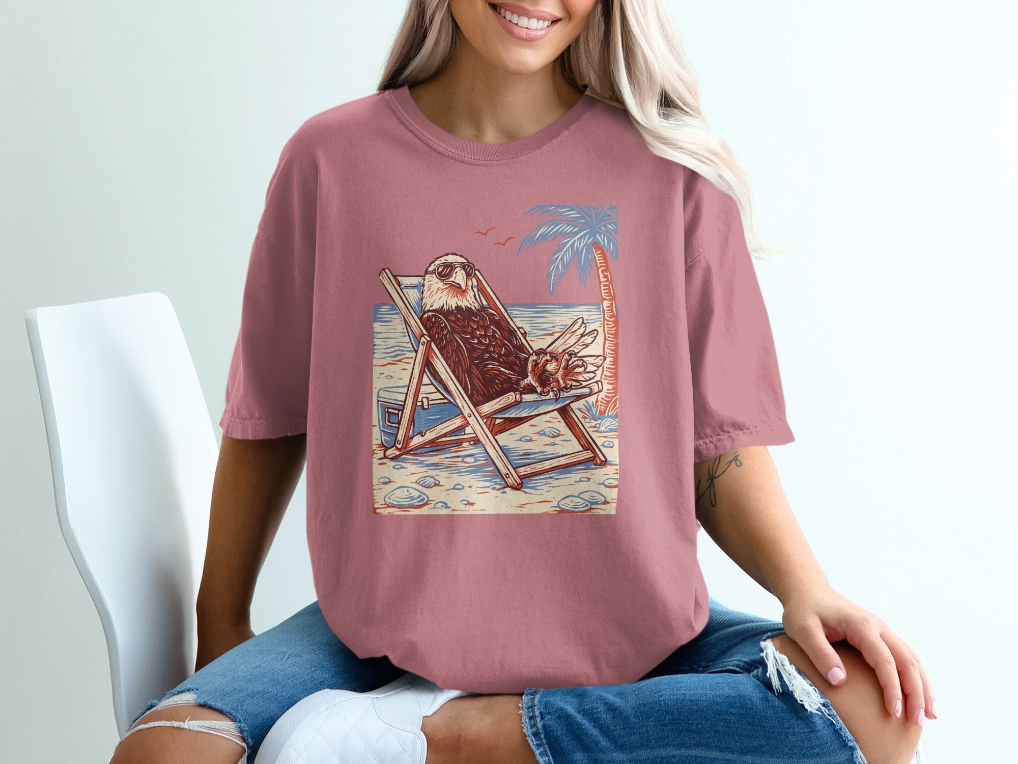 Eagle with sunglasses relaxing in a beach chair with palm tree.