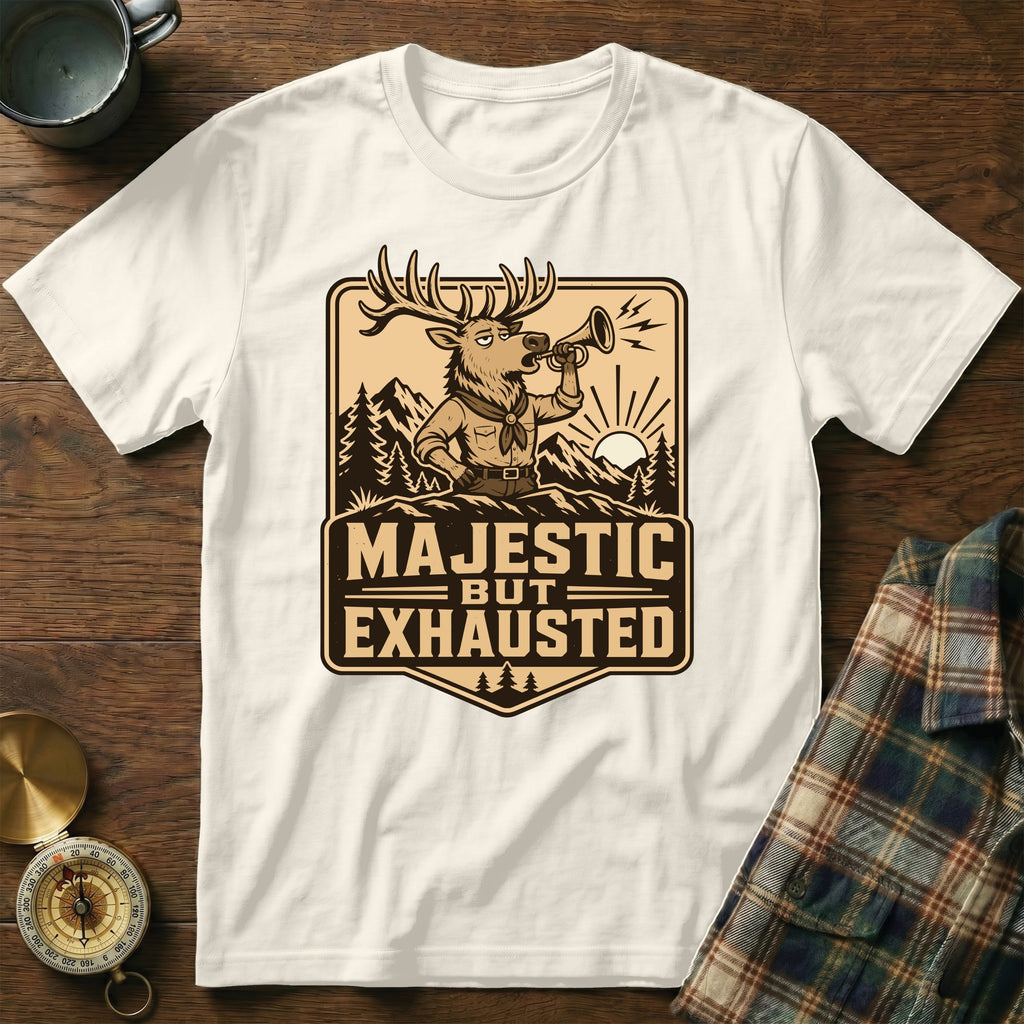 White t-shirt with graphic of a deer blowing a horn, text reads "MAJESTIC BUT EXHAUSTED".