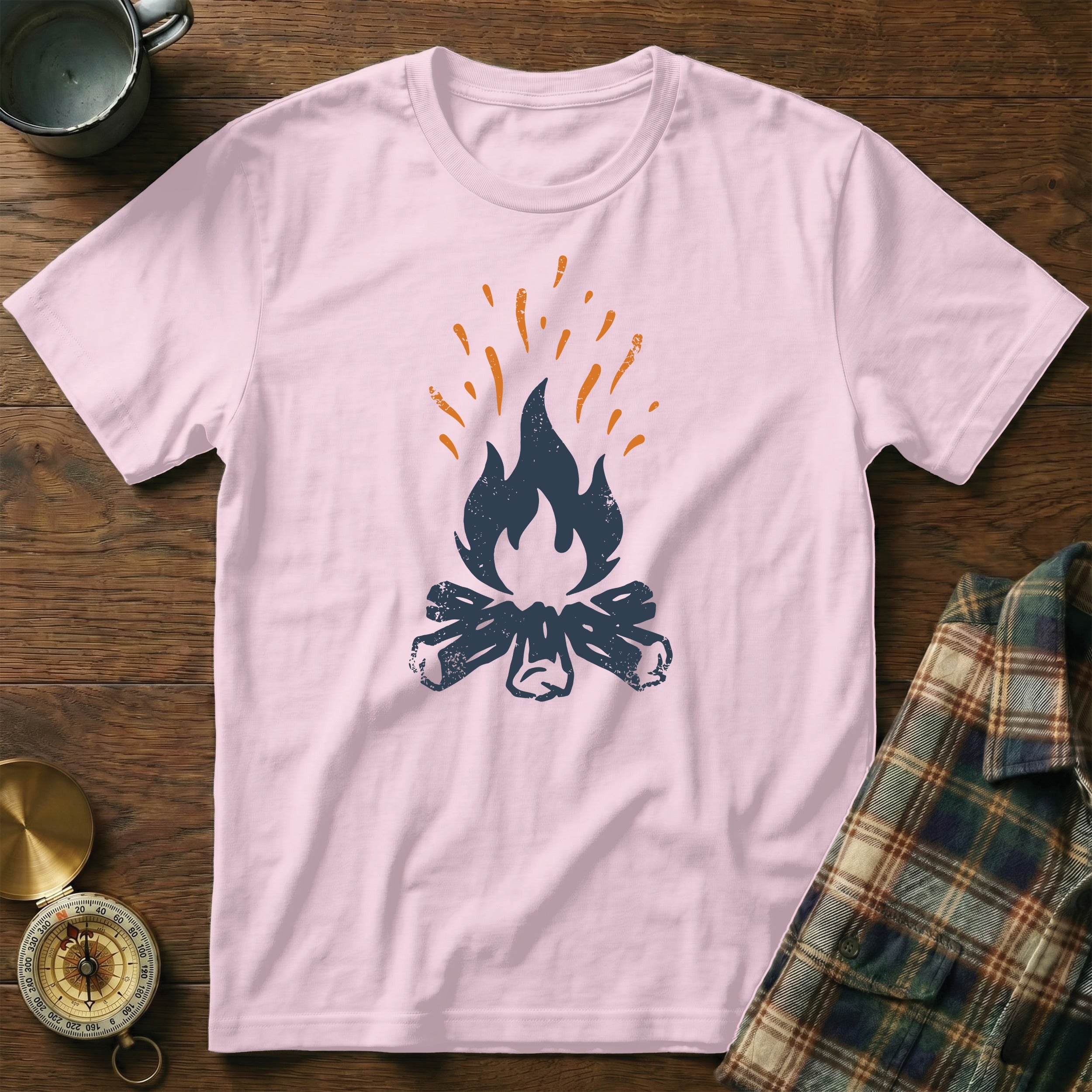 Pink t-shirt with navy blue campfire graphic and orange sparks.