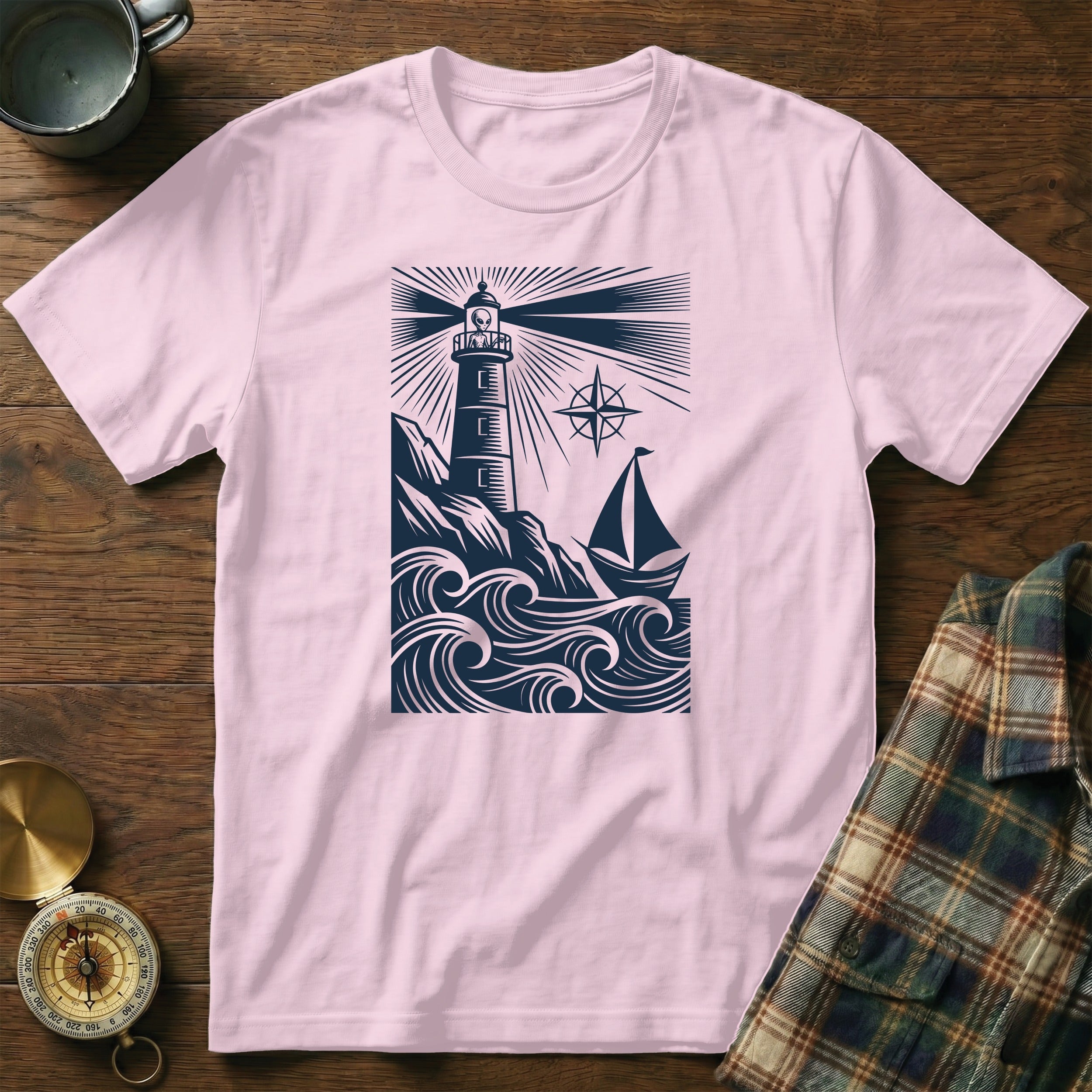 Pink t-shirt with a dark blue lighthouse, sailboat, and waves design.