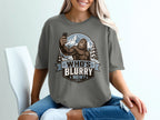 Bigfoot taking a selfie with mountains and trees, text reads "Who's Blurry Now?".