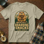T-shirt with a groundhog hoarding snacks, mountains, and text "Hoarding Snacks Since Birth".