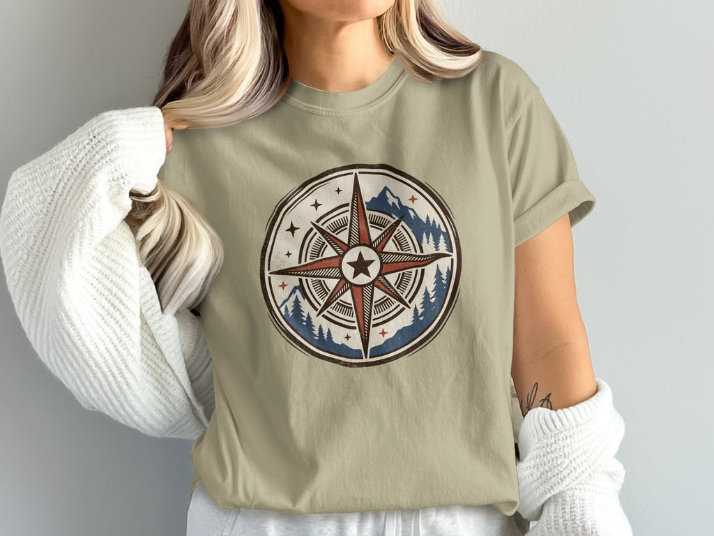 T-shirt with a tribal compass design featuring mountains and pine trees.