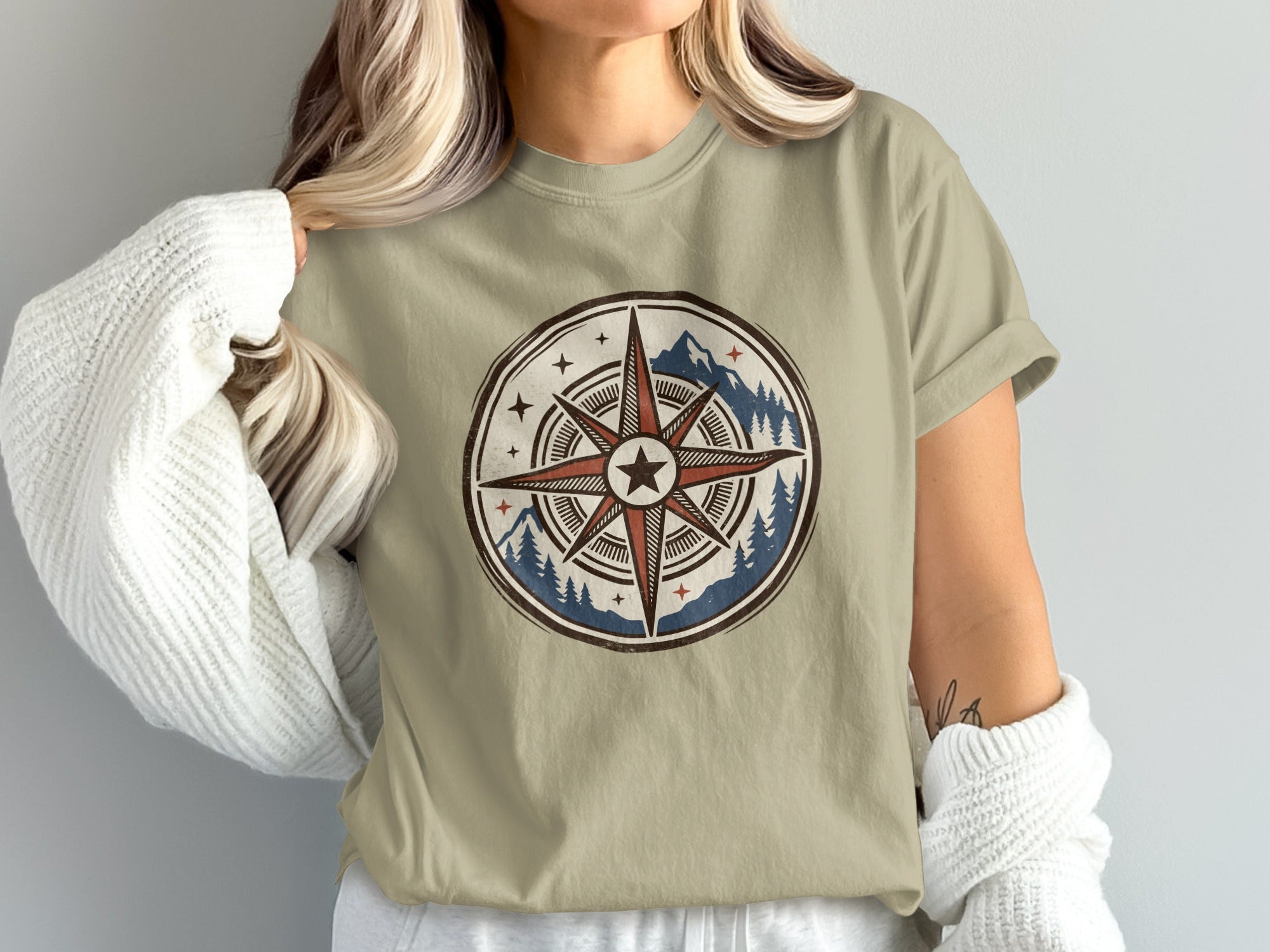 T-shirt with a tribal compass design featuring mountains and pine trees.