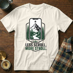 Cream t-shirt with "Less Scroll. More Stroll." and phone screen landscape graphic.