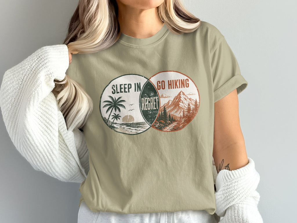 T-shirt graphic with Venn diagram showing "Sleep In" and "Go Hiking" with "Regret" in the overlap.