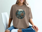 Brown t-shirt with circular nature graphic featuring starfish, rocks, and ocean plants.