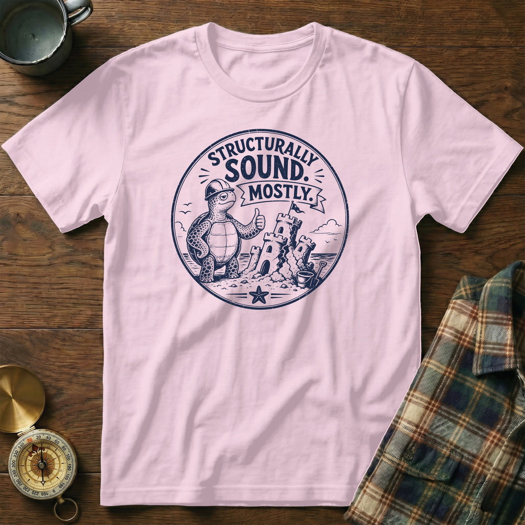 Pink t-shirt with a graphic of a turtle giving a thumbs up next to a sandcastle.