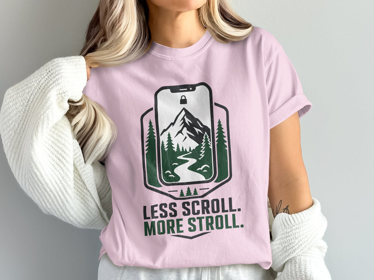 Pink t-shirt with "Less Scroll. More Stroll." text and nature graphic.