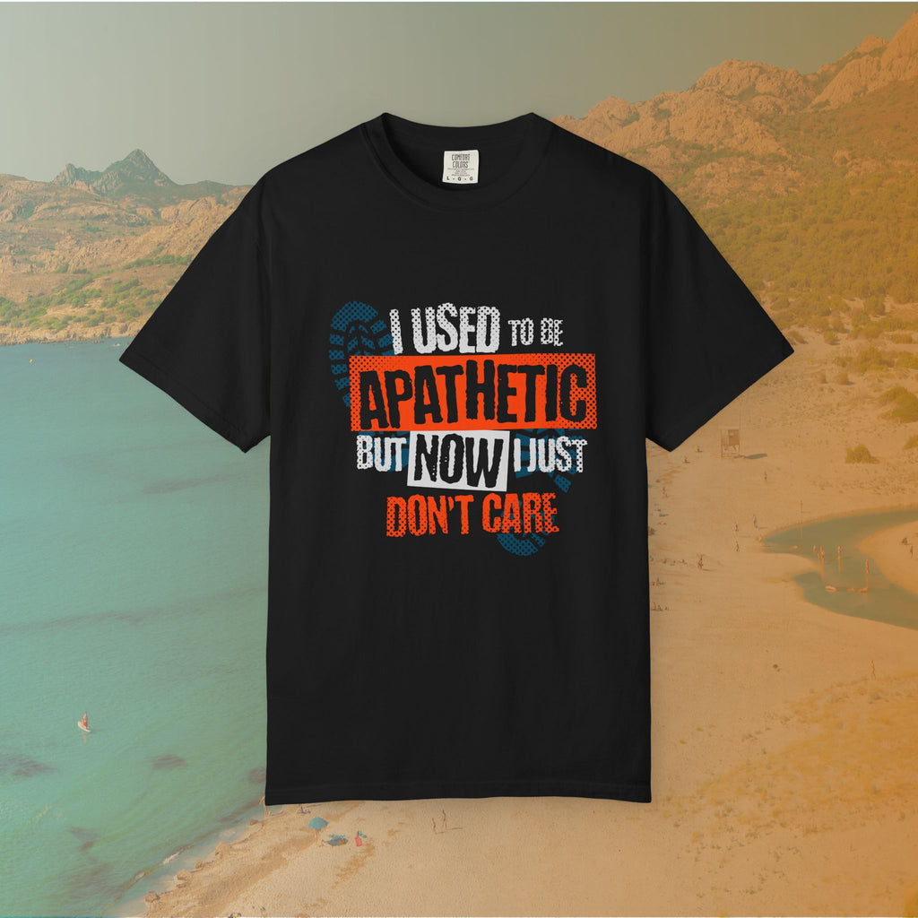 black Graphic T-shirt featuring the layered, distressed text: "I USED TO BE APATHETIC BUT NOW I JUST DON'T CARE," overlaid with halftone dot textures and boot print graphics.