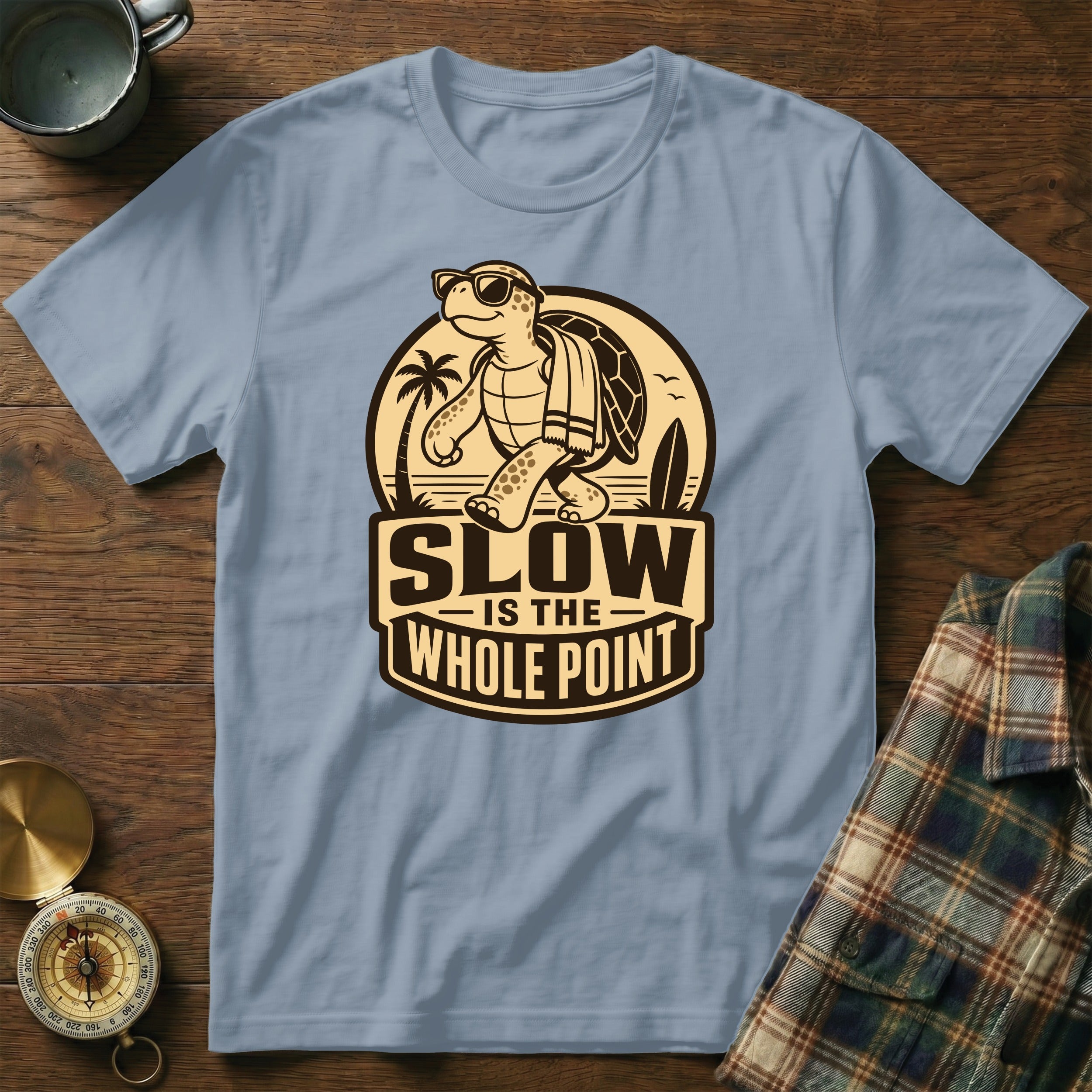 Light blue t-shirt with cartoon turtle graphic and "SLOW IS THE WHOLE POINT" text.