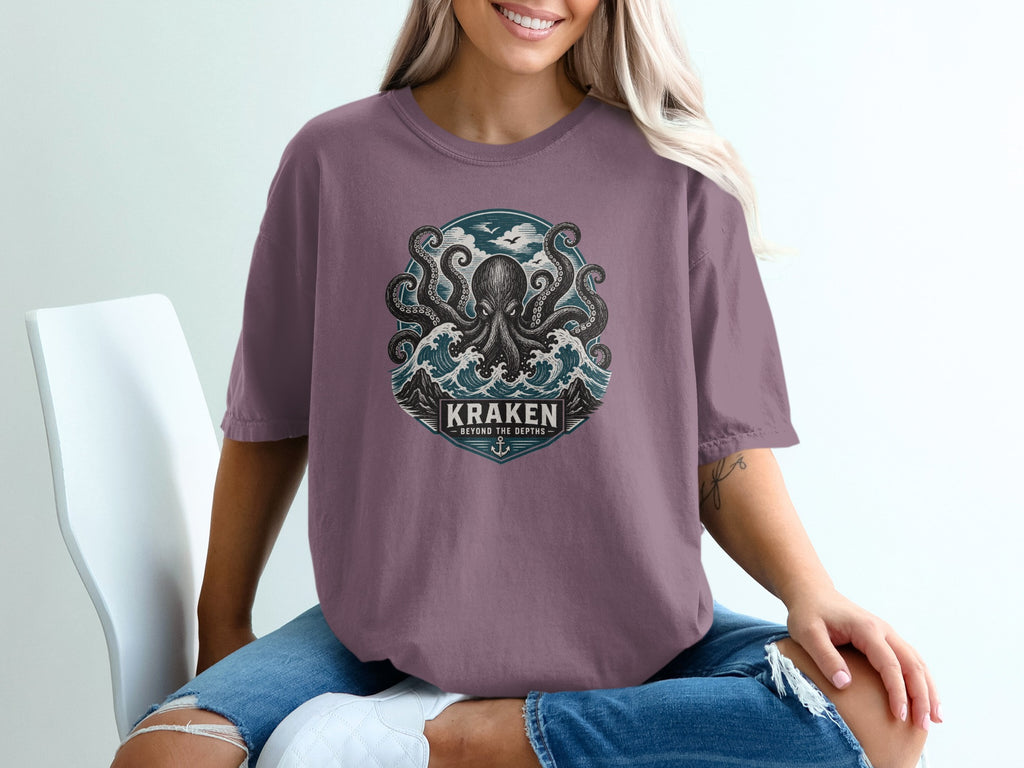 T-shirt graphic with kraken, waves, sky, and text "KRAKEN BEYOND THE DEPTHS".
