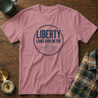 Rose t-shirt with "LIBERTY LOOKS GOOD ON YOU" text and mountain graphic.