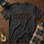 Black t-shirt with "LIBERTY LOOKS GOOD ON YOU" text and mountain graphics.