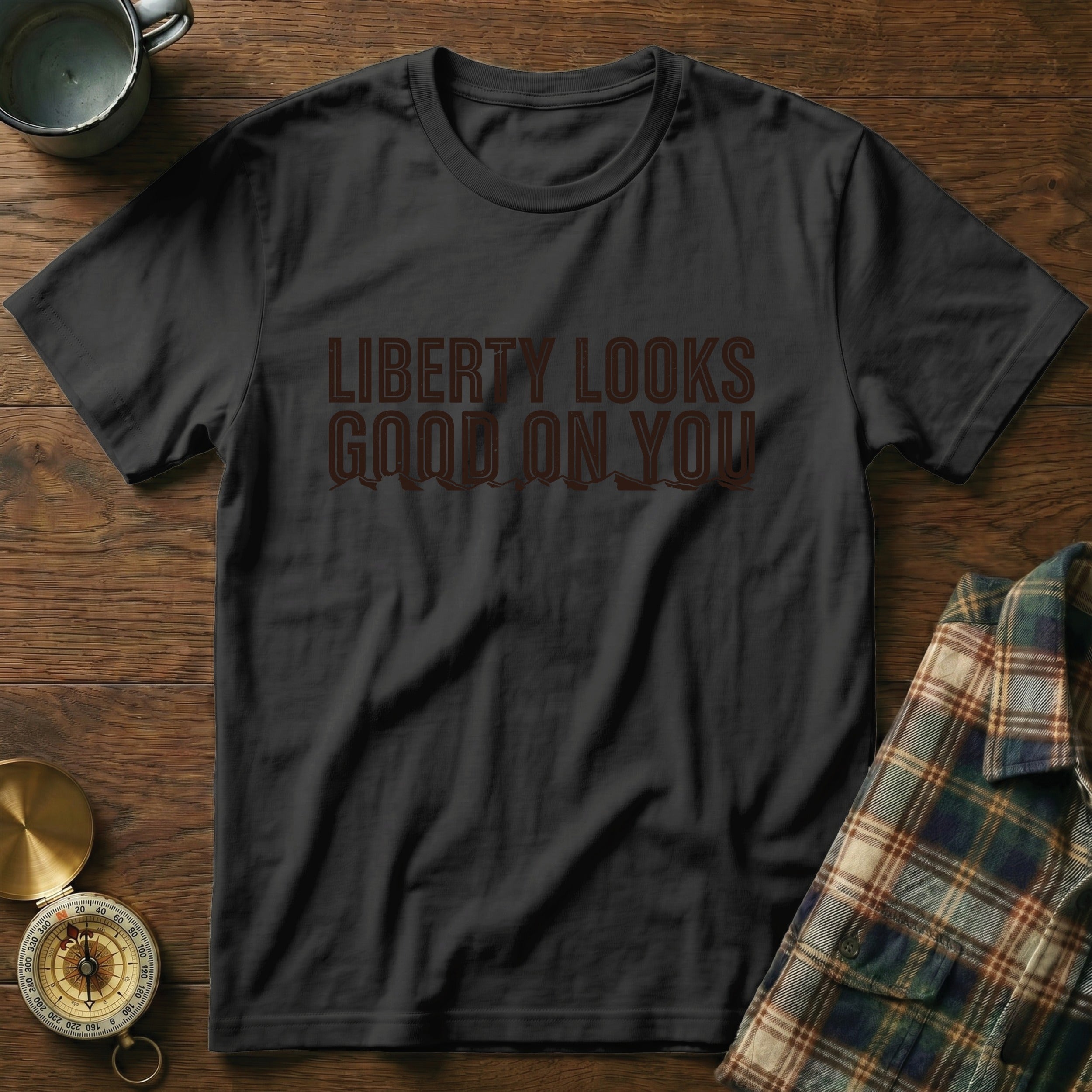 Black t-shirt with "LIBERTY LOOKS GOOD ON YOU" text and mountain graphics.